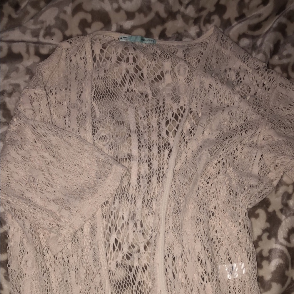 Lacy cream-colored cardigan.